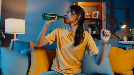 Happy young asian woman looking at camera enjoy night party event online with friends toast drink...