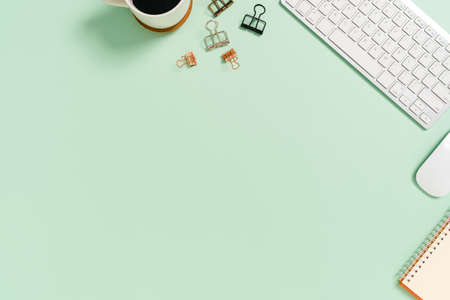 Minimal work space - Creative flat lay photo of workspace desk. Top view office desk with keyboard and mouse on pastel green color background. Top view with copy space, flat lay photography.の写真素材