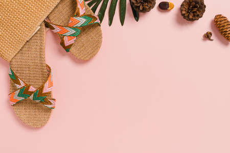 Creative flat lay photo of travel vacation spring or summer tropical fashion. Top view beach accessories on pastel pink color background with blank space for text. Top view copy space photography.の写真素材