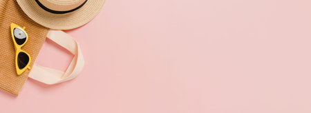 Creative flat lay of travel vacation spring or summer tropical fashion. Top view beach accessories on pastel pink color background. Panoramic banner with copy space for text and Advertising area.の写真素材