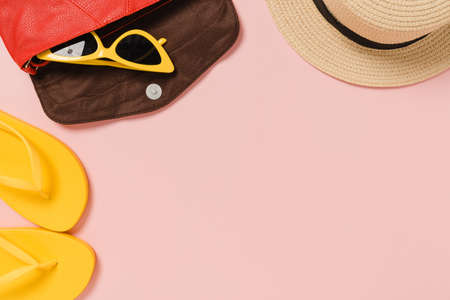 Creative flat lay photo of travel vacation spring or summer tropical fashion. Top view beach accessories on pastel pink color background with blank space for text. Top view copy space photography.の写真素材