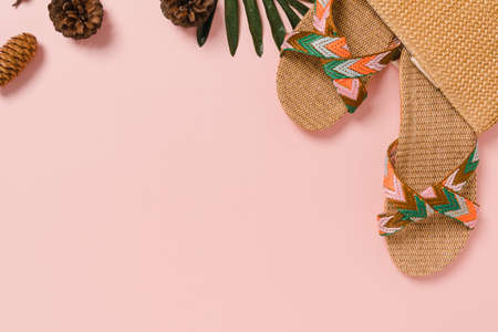 Creative flat lay photo of travel vacation spring or summer tropical fashion. Top view beach accessories on pastel pink color background with blank space for text. Top view copy space photography.の写真素材