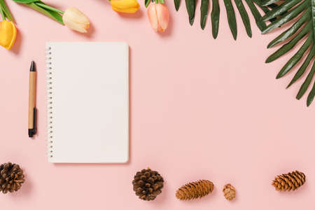 Creative flat lay of travel vacation spring or summer tropical fashion. Top view beach accessories open mockup black notebook for text on pastel background. Top view mock up copy space photography.の写真素材