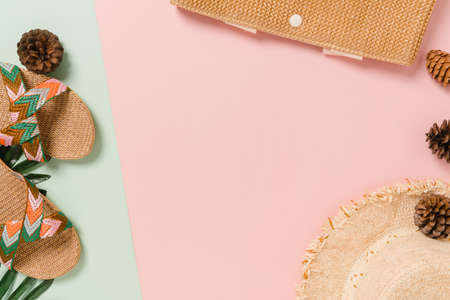Creative flat lay of travel vacation spring or summer tropical fashion. Top view beach accessories on pastel green pink color background with blank space for text. Top view copy space photography.の写真素材