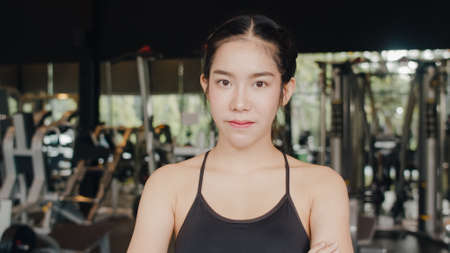 Happy Asian healthy sport woman trainer with sportswear smile looking at camera feel cheerful and fresh after workout in gym, People training use in fitness class, sport and healthy lifestyle concept.の写真素材