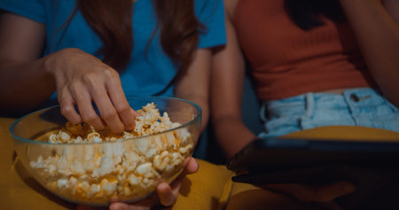 Attractive Asia ladies with casual enjoy happy moment focus watch online movie entertainment on...