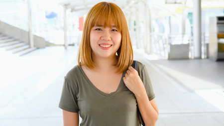 Asian student women reading books in library at university. Young undergraduate girl do homework,...