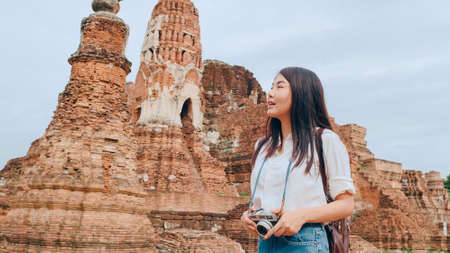 Traveler Asian woman spending holiday trip at Ayutthaya, Thailand, Japanese backpacker female enjoy her journey at amazing landmark in traditional city. Lifestyle women travel holidays concept.の写真素材