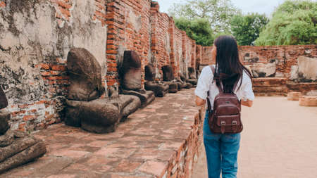 Traveler Asian woman spending holiday trip at Ayutthaya, Thailand, Japanese backpacker female enjoy her journey at amazing landmark in traditional city. Lifestyle women travel holidays concept.の写真素材
