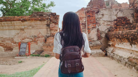 Traveler Asian woman spending holiday trip at Ayutthaya, Thailand, Japanese backpacker female enjoy her journey at amazing landmark in traditional city. Lifestyle women travel holidays concept.の写真素材