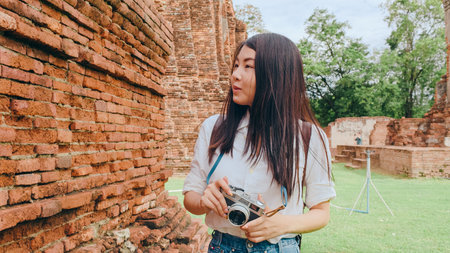 Traveler Asian woman spending holiday trip at Ayutthaya, Thailand, Japanese backpacker female enjoy her journey at amazing landmark in traditional city. Lifestyle women travel holidays concept.の写真素材