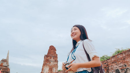 Traveler Asian woman spending holiday trip at Ayutthaya, Thailand, Japanese backpacker female enjoy her journey at amazing landmark in traditional city. Lifestyle women travel holidays concept.の写真素材