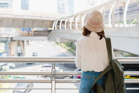 Traveler backpacker asian woman travel in Bangkok, Thailand. Happy young female spending holiday trip at amazing landmark and enjoy her journey in traditional city.の写真素材