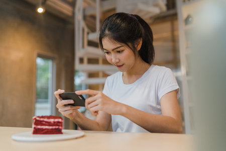 Freelance Asian women using mobile phone at office. Young Japanese Asia Girl using smartphone...