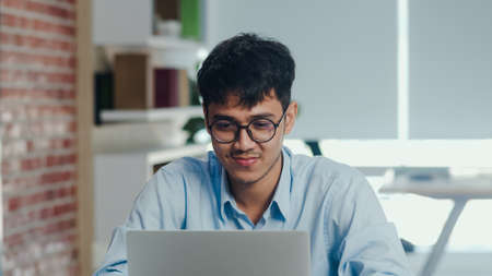 Asian creative man drawing work plan on paper board. Young professional business male think and write information reminder on paper on brick, business situation, startup in Loft office concept.の写真素材