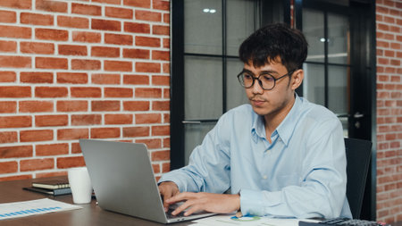 Asian creative man drawing work plan on paper board. Young professional business male think and write information reminder on paper on brick, business situation, startup in Loft office concept.の写真素材