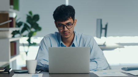 Asian creative man drawing work plan on paper board. Young professional business male think and write information reminder on paper on brick, business situation, startup in Loft office concept.の写真素材