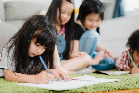 Group of children drawing in classroom, Multi-ethnic young boys and girls happy funny study and play painting on paper at elementary school. Kids drawing and painting at school concept.の写真素材