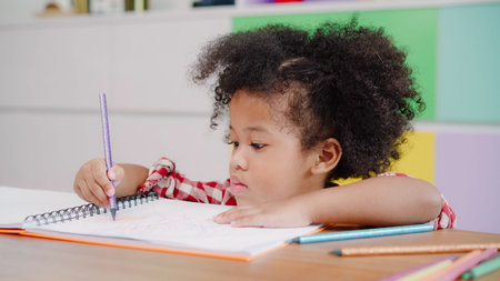 African kids drawing and do homework in classroom, young girl happy funny study and play painting on...