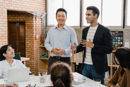 Multiracial group of young creative people in smart casual wear discussing business brainstorming meeting ideas mobile application software design project in modern office. Coworker teamwork concept.の写真素材