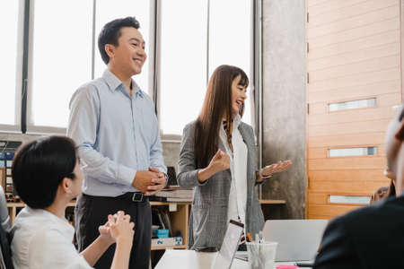 Multiracial group of young creative people in smart casual wear discussing business brainstorming meeting ideas mobile application software design project in modern office. Coworker teamwork concept.の写真素材