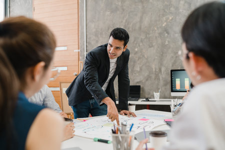 Collaborative process of multicultural businesspeople using computer presentation and communication meeting brainstorming ideas about project colleagues working plan success strategy in modern office.の写真素材