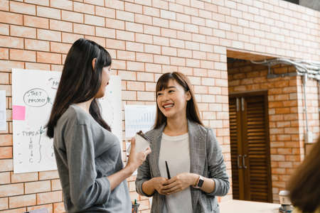 Asia businesspeople chatting to intern discussing job interview colleagues having conversation and communication meeting brainstorming ideas about project working plan success strategy in office.の写真素材