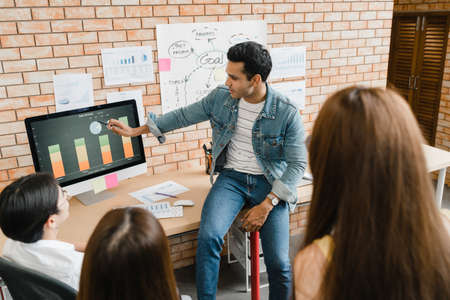 Collaborative process of multicultural businesspeople using computer presentation and communication meeting brainstorming ideas about project colleagues working plan success strategy in modern office.の写真素材
