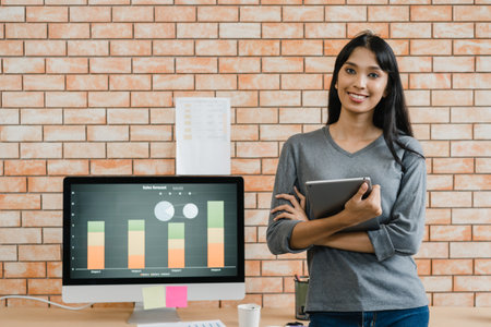 Portrait of successful beautiful executive businesswoman smart casual wear looking at camera and smile, arms crossed in modern office workplace. Young Asia lady standing in contemporary meeting room.の写真素材
