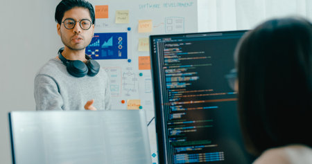 Group adult Asia male female software developers mentor leader manager talk strategy plan to executive write prompt AI bot IT app program nomad, video game, data center. Whiteboard slideshow code.の写真素材