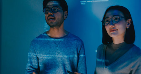 Group adult Asia male female software developers mentor leader manager talk strategy plan to executive write prompt AI bot IT app program nomad, video game, data center. Projecting slideshow code.の写真素材
