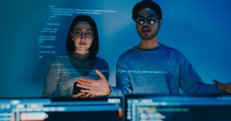 Group adult Asia male female software developers mentor leader manager talk strategy plan to executive write prompt AI bot IT app program nomad, video game, data center. Projecting slideshow code.の写真素材