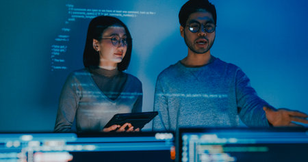 Group adult Asia male female software developers mentor leader manager talk strategy plan to executive write prompt AI bot IT app program nomad, video game, data center. Projecting slideshow code.の写真素材