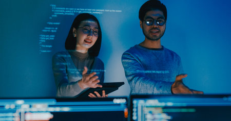Group adult Asia male female software developers mentor leader manager talk strategy plan to executive write prompt AI bot IT app program nomad, video game, data center. Projecting slideshow code.の写真素材