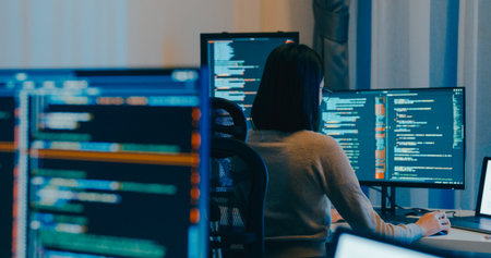 Young Asia female freelance eyeglasses typing write prompt AI bot IT app smart program nomad, video game, terminal with coding language, designer, big data center on desktop computer in night office.の写真素材