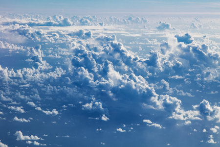 A view of a cloudy sky from a flying airplane.