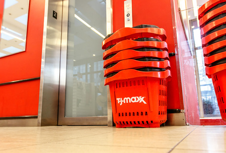 New York, February 6, 2017: A stack of red plastic shopping baskets stand by an elevator door on the second floor of a TJ Maxx store.のeditorial素材