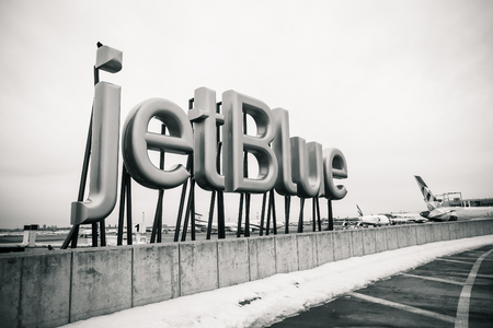 New York, March 18, 2017: jetBlue sign is displayed near the entrance to the jetBlue terminal of the JFK airport.のeditorial素材