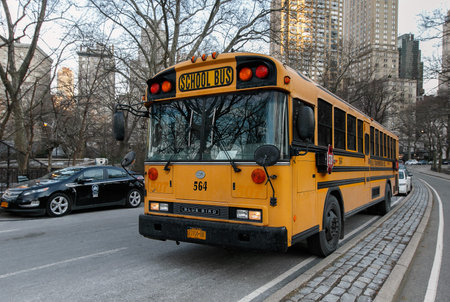 New York, February 6, 2017: An empty school bus is waiting parked on the East Drive of Central Park.