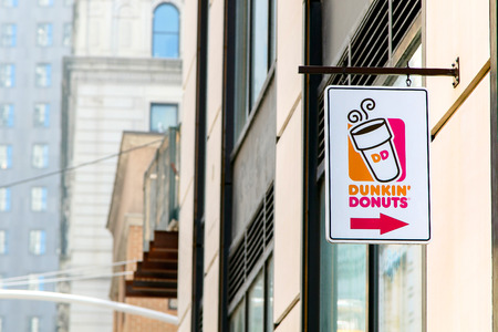 New York, April 28, 2017: A sign over an entrance to a Dunkin Donuts location in Manhattan.のeditorial素材
