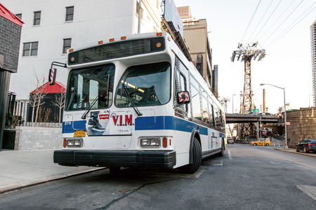 New York, February 6, 2017: An empty idle MTA bus is parked during the driver's break.のeditorial素材