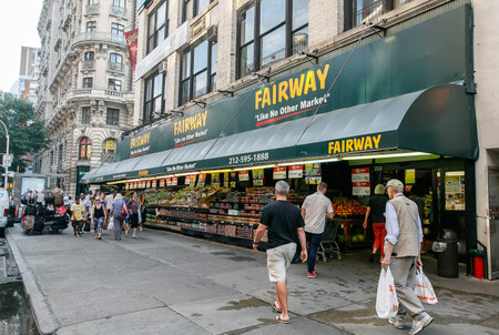 New York, August 3, 2017: People walk by Fairway supermarket on Broadway.
