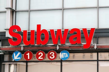 New York, July 27, 2017: Subway sign above the entrance to the underground public transportation network of trains.のeditorial素材