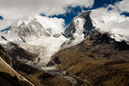 A mountain range is partially covered by clouds in Peru's region of Huarazの写真素材