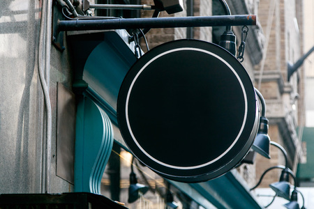 Generic black round sign over a shop entrance. Copy space, insert your own text or graphics.の写真素材