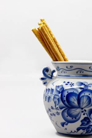 Bread sticks in a porcelain piece of pottery.の写真素材