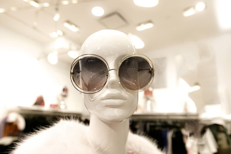 Closeup of a female mannequin wearing an oversized round sunglasses and a fur coat.の写真素材