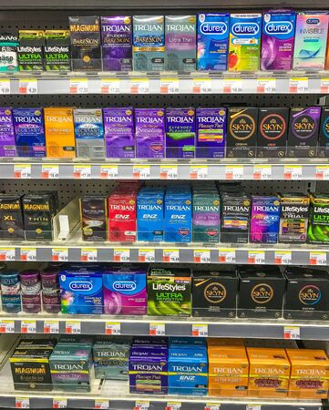 New York, 2/27/2019: Packs of various condoms stand on a shelf of a Walgreens drug store.のeditorial素材