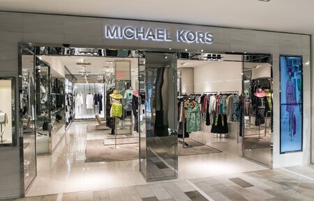 New York, 3/11/2019: Dresses and other clothing items hang at the Michael Kors section at Bloomingdale's department store in Manhattan awaiting attention from customers.のeditorial素材