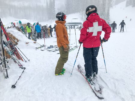 Park City, UT, 2/3/2019: Skier is having a conversation with a ski patroller at Deer Valley resort.のeditorial素材
